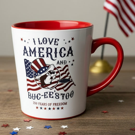 White mug with red interior and handle on top of cardboard boxes