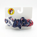 A patriotic hair scrunchie with sections of red, white, and navy blue fabric. The fabric is printed with the Buc-ee's beaver mascot wearing an Uncle Sam-style hat. It is shown on an official Buc-ee's white retail card.