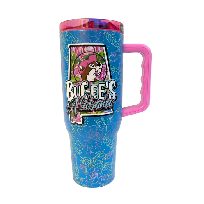 Front view of a blue 40 oz Buc-ee's Alabama travel tumbler against a plain white backdrop. The tumbler features an all-over pattern of pink and yellow outlined roses, a large pink handle on the right, and a prominent central graphic of the state of Alabama outline filled with roses, featuring the Buc-ee's mascot and the text "Buc-ee's Alabama."