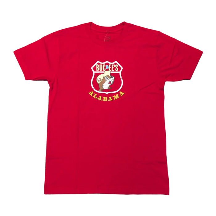Front view of a vibrant red short-sleeve crew neck t-shirt laid flat on a white background, featuring a white highway shield logo on the chest enclosing a cartoon beaver mascot with the words "Buc-ee's Alabama."