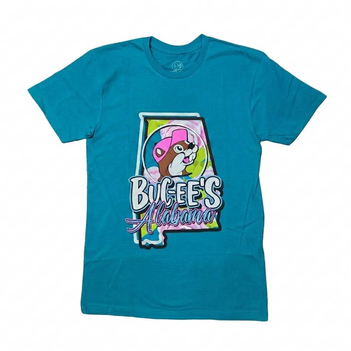 A bright turquoise blue short-sleeve crew neck t-shirt laid flat on a white background, featuring a large graphic of the state of Alabama filled with a pink and green floral pattern, the Buc-ee's beaver mascot in a pink hat, and text reading "Buc-ee's Alabama".