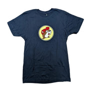 Front view of a Buc-ee's Alabucceebama navy blue short-sleeve t-shirt laid flat on a white surface, featuring a small, circular yellow Buc-ee's logo on the center chest containing a cartoon beaver mascot wearing a red hat.