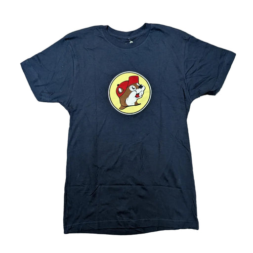 Front view of a Buc-ee's Alabucceebama navy blue short-sleeve t-shirt laid flat on a white surface, featuring a small, circular yellow Buc-ee's logo on the center chest containing a cartoon beaver mascot wearing a red hat.