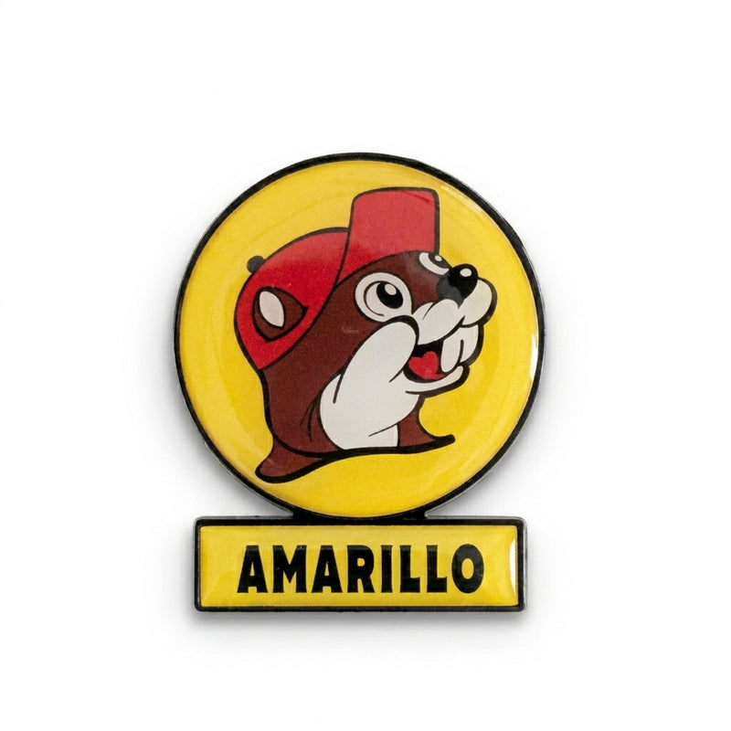 A circular yellow souvenir fridge magnet shaped like a Buc-ee's highway billboard sign on a solid white background. It features the smiling beaver mascot logo in a red cap inside a yellow circle, mounted over a rectangular yellow bar that reads "AMARILLO" in bold black lettering.