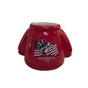A product shot of a commemorative Buc-ee’s America 250 scented candle. The ceramic vessel is shaped like a bright red sweater with ribbed texture at the neck and hem. The front features the Buc-ee’s beaver mascot wearing an Uncle Sam hat in front of a waving American flag, with the text "AMERICA 250" and "1776 - 2026" printed below. The candle is shown on a white background.