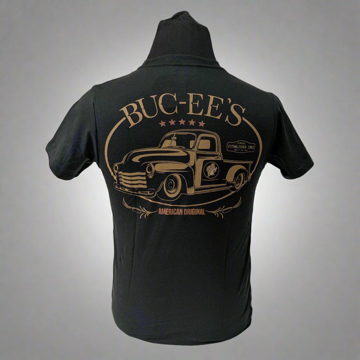 Back of a black Buc-ee’s t-shirt with a large vintage-style truck graphic in bronze and “BUC-EE’S – American Original” text.