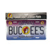 Official Buc-ee's Arizona Collectible License Plate in its clear plastic packaging. The metal plate features a purple-to-blue desert gradient background with a white silhouette of the state of Arizona, large white text spelling "BUC-EE'S", and the iconic beaver mascot in the center. Displayed on a clean white background.