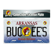 Buc-ee's Arkansas collectible decorative license plate in plastic packaging, featuring the text "ARKANSAS" and "BUC-EE'S" with the beaver logo, an Arkansas state outline, and "Beaver Believer" written along the bottom.