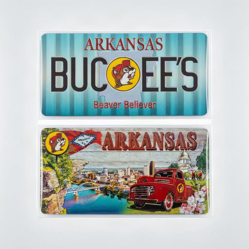Two Arkansas Buc-ee magnets featuring the Buckeye logo and a scenic vintage-style illustration, displayed against a light gray background.