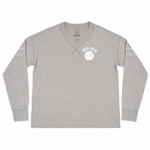 Front view of a mineral-washed ash grey V-neck long-sleeve tunic shirt with a white Buc-ee's logo on the left chest, cross-stitch neckline detail, and sleeve stripes.