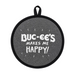 Round gray Buc-ee’s heat-resistant hot pad with black trim featuring the phrase “Buc-ee’s Makes Me Happy!” in white lettering and a hanging loop at the top. Displayed on a clean white background.