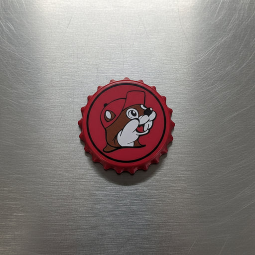 A red Bottle Cap Opener that has the Buc-ee's logo on the front with a bottle cap style. 