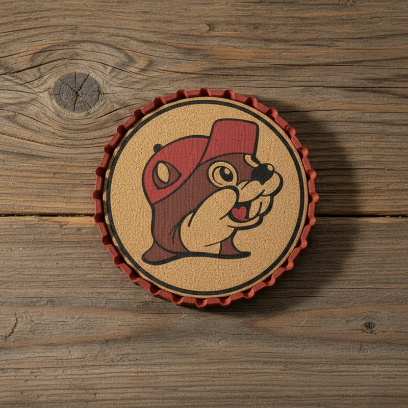 Buc-ee’s Beaver Metal Bottle Cap Coaster — featuring a cork center, bold red metal edge, and the famous Buc-ee’s beaver logo. Perfect for home bars and Buc-ee’s fans!