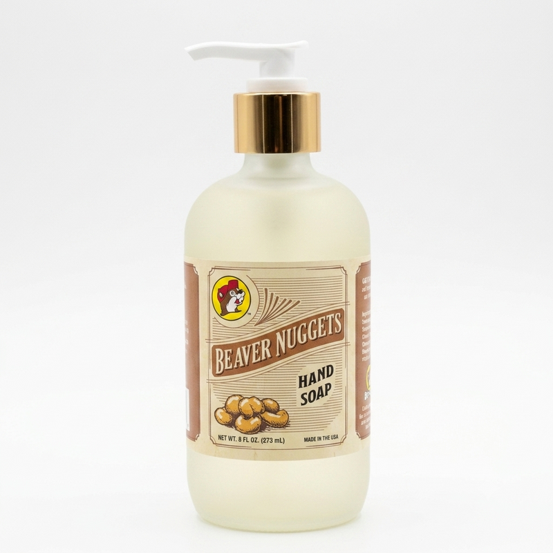 Front view of an 8 oz bottle of Buc-ee's Beaver Nuggets Hand Soap. The bottle features a frosted finish, a white pump with a gold accent collar, and a rustic label showcasing the iconic Buc-ee's beaver logo, set against a white background.