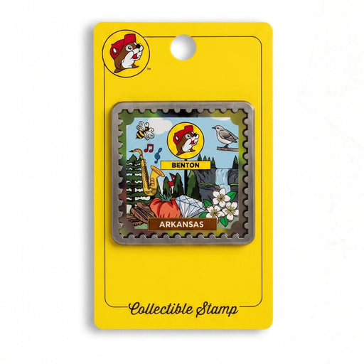 A collectible Arkansas stamp magnet mounted on a bright yellow backing card. The stamp features a colorful illustration of the Little Rock State Fair in Arkansas, including a bull, elephant, and fairground scene.