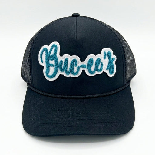 Buc-ee’s Black Trucker Hat with Teal Script Logo white background. 
