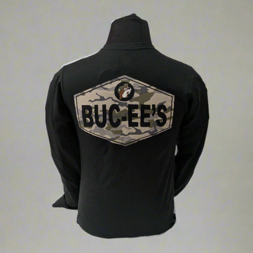 Back view of a black long sleeve Buc-ee’s shirt featuring a large camouflage patch with the Buc-ee’s logo and “BUC-EE’S” text, displayed on a mannequin in front of a white draped background.