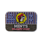 Front view of a rectangular Buc-ee's Blast Pop Mints metal tin on a white background. The top half features blue, white, and red stripes with a yellow circle displaying the Buc-ee's beaver mascot. The bottom half is dark grey with the words "MINTS BLAST POP" in bold white and red text.