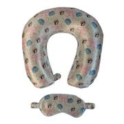 A travel sleep set consisting of a U-shaped neck pillow and a matching eye mask. Both items are made of a very light green fabric featuring a repeating "Blossoms and Bows" pattern of pink ribbons, blue flowers, and the Buc-ee's beaver mascot. Displayed on a clean white background.