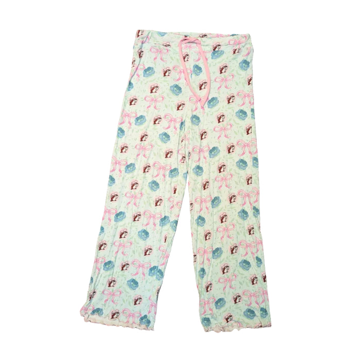 A top-down view of the Adult Blossoms & Bows Pajama Pants. The pants feature a very light green fabric with an all-over print of pink bows, blue flowers, and the Buc-ee's beaver. They include a wide elastic waistband with a functional pink drawstring and ruffled lettuce-edge hems at the bottom of the legs. Displayed on a clean white background.