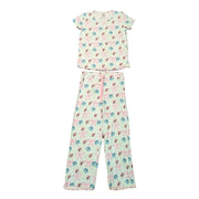 A top-down view of the Adult Blossoms & Bows Pajama Set pieces. A light green short-sleeve shirt is positioned above the matching pajama pants. Both pieces feature the signature pattern of pink bows, blue flowers, and the Buc-ee's beaver mascot. The pants include a functional pink drawstring at the waist, and both the shirt and pant cuffs are finished with a ruffled lettuce-edge hem. Displayed on a clean white background.