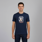 Man wearing a navy blue t-shirt with a logo and text on a gray background