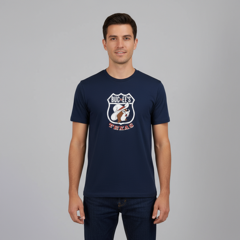 Man wearing a navy blue t-shirt with a logo and text on a gray background