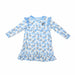 Light blue and white toddler gown with long sleeves, ruffled hem, snow-leopard heart pattern, and a small Buc-ee’s logo patch on the chest, displayed on a clean white background.