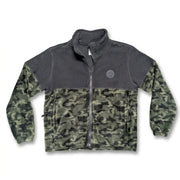 A front photo of a Buc-ee's Youth Camo Colorblock Fleece Jacket. The jacket features a solid charcoal grey upper yoke, a dark woodland camouflage lower body and sleeves, side zip pockets, and a round grey Buc-ee's beaver logo patch on the left chest.