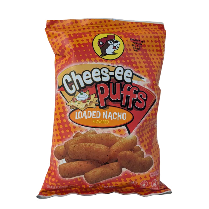 A 2 oz bag of Buc-ee’s "Chees-ee Puffs" in Loaded Nacho flavor. The packaging is bright orange with a red halftone dot pattern. It features the Buc-ee's beaver logo at the top and an illustration of nacho chips with sour cream and jalapeños. Large, rounded corn puffs are pictured at the bottom. Displayed on a clean white background.