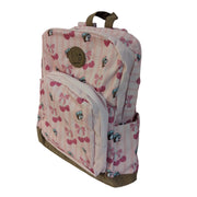 A side view of a light pink Buc-ee's 16-inch backpack featuring vertical stripes, pink cherry bow graphics, mini beaver mascot prints, brown bottom trim, and a faux-leather Buc-ee's patch. Side view shows the slide in water bottle pocket.