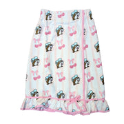 An overhead view of a Buc-ee's Cherry Towel Wrap, a vertically striped pink and white spa towel wrap with an allover print of the Buc-ee's beaver mascot, bows, and pink cherries. It features an adjustable Velcro and elastic closure at the top and a ruffled hem accented with a pink bow. Displayed on a white background.