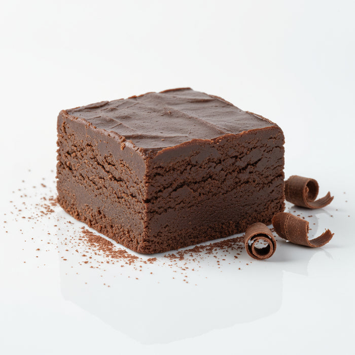 Square piece of chocolate fudge on a white surface