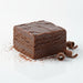 Square piece of chocolate fudge on a white surface