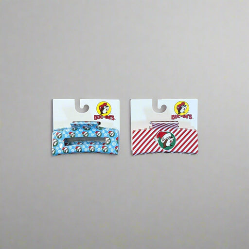 Buc-ee’s Christmas Hair Claws in Snowflake (blue) and Peppermint (red) designs with holiday prints.