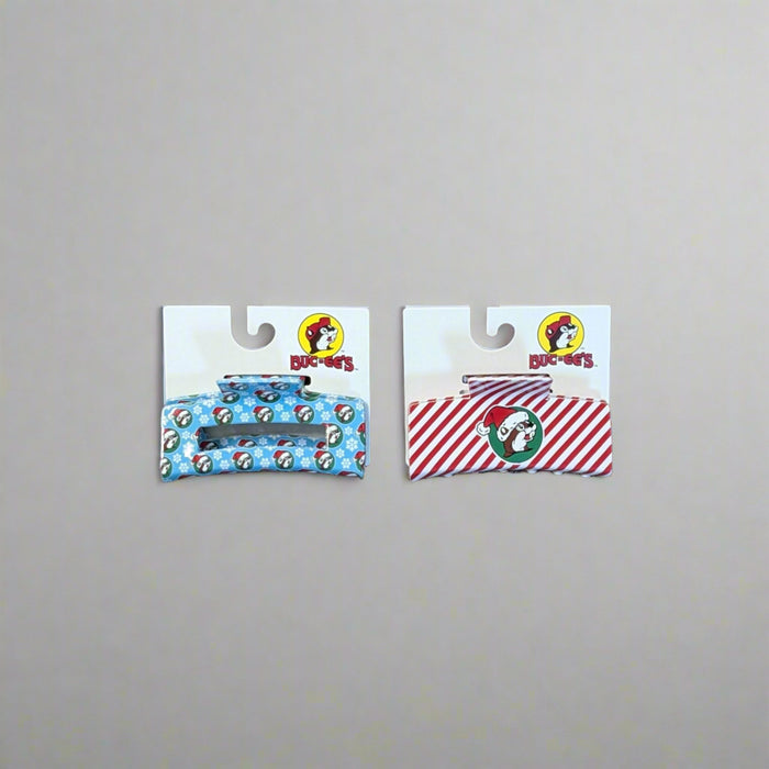 Buc-ee’s Christmas Hair Claws in Snowflake (blue) and Peppermint (red) designs with holiday prints.