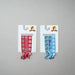 Two packs of Buc-ee’s Christmas Hair Ties – one blue Snowflake set and one red Peppermint set, each with Buc-ee holiday designs.