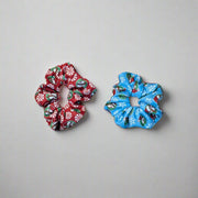 Set of Buc-ee’s Holiday Scrunchies in Snowflake (blue with snowflakes) and Peppermint (red with candy designs)