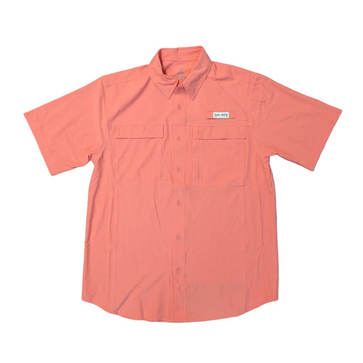 A front view of a solid coral-colored, short-sleeved Buc-ee's performance fishing shirt laid flat on a clean white background. The shirt features a traditional collar, a full button front, and two large chest pockets with horizontal flap closures. A small white "Buc-ee's" logo patch is positioned above the left pocket, and breathable micro-perforation panels are visible on the side torso.