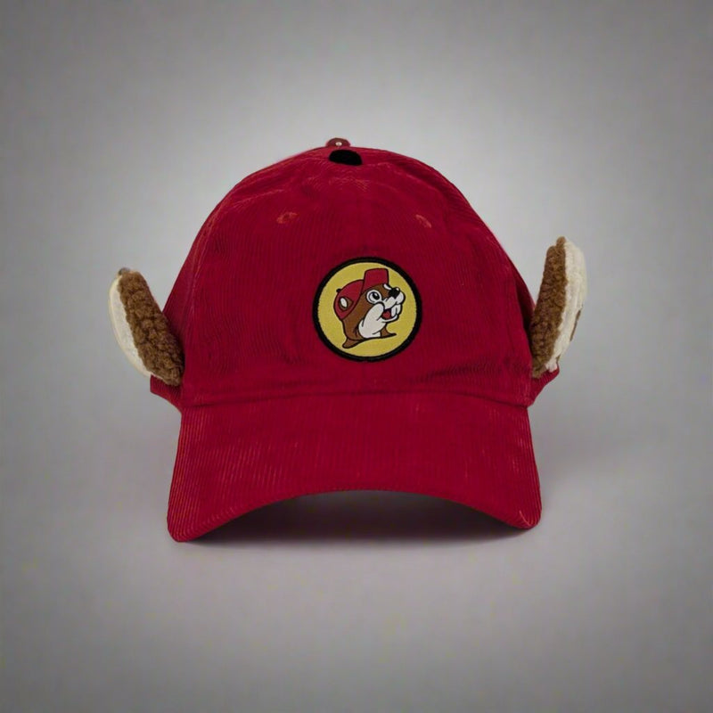 A red corduroy Buc-ee’s hat featuring plush ear flaps and the iconic Buc-ee’s logo embroidered on the front.




