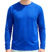 Man wearing a blue long-sleeve shirt on a beach