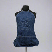 A denim blue Buc-ee's apron featuring an embossed logo with Bucky the Beaver, displayed on a mannequin.