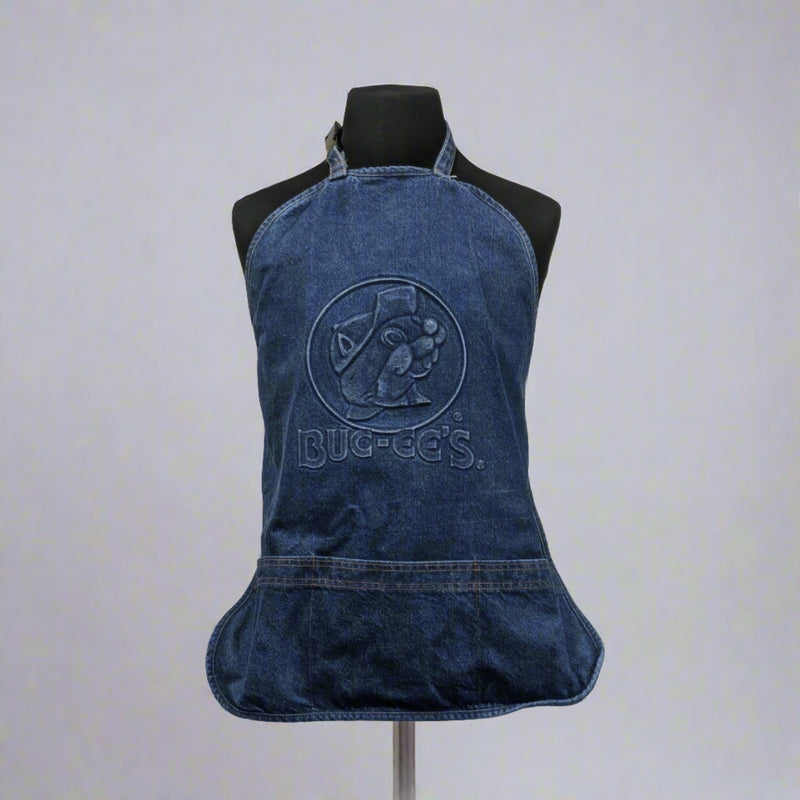 A denim blue Buc-ee's apron featuring an embossed logo with Bucky the Beaver, displayed on a mannequin.