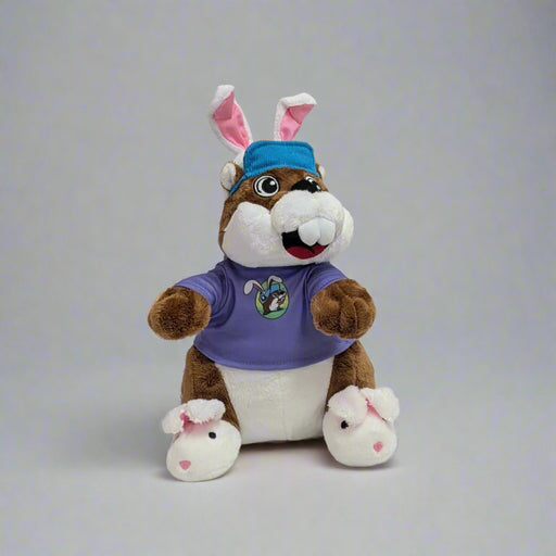 Buc-ee's Easter Plushie with bunny ears and a blue hat. Bunny slippers on with the purple pastel theme Easter shirt. 