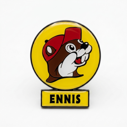 A lollipop Buc-ee's magnet featuring the Buc-ee's beaver mascot wearing a red hat against a yellow background. Attached to the bottom is a yellow rectangular bar displaying the town name "ENNIS" in bold, black block letters.