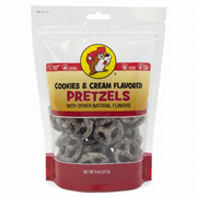 An 8 oz, stand-up resealable bag of Buc-ee's Cookies & Cream Flavored Pretzels. The pretzels are visible through the transparent bottom section of the bag, showing a white, cookie-speckled coating. The bag is centered on a clean white background.