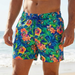 Man wearing colorful floral swim shorts on a beach