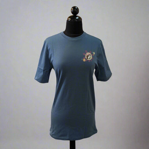 Front view of a blue Buc-ee’s floral t-shirt with a small Buc-ee’s logo surrounded by flowers on the chest, displayed on a mannequin.