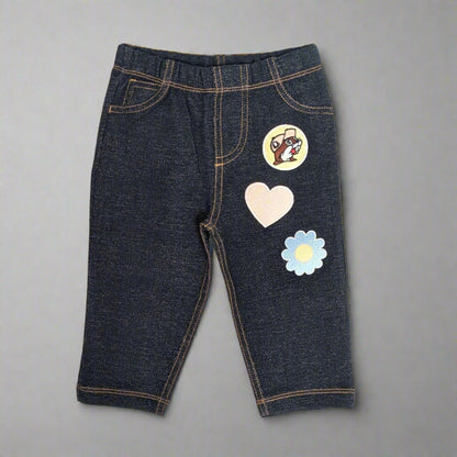 Buc-ee's Flower Heart Jeans for kids. Has a Buc-ee logo, heart, and flower on the front leg of the jeans. 