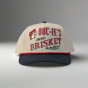 Front view of Buc-ee’s hat featuring embroidered "Fresh Brisket on the Board" text and Buc-ee the Beaver logo